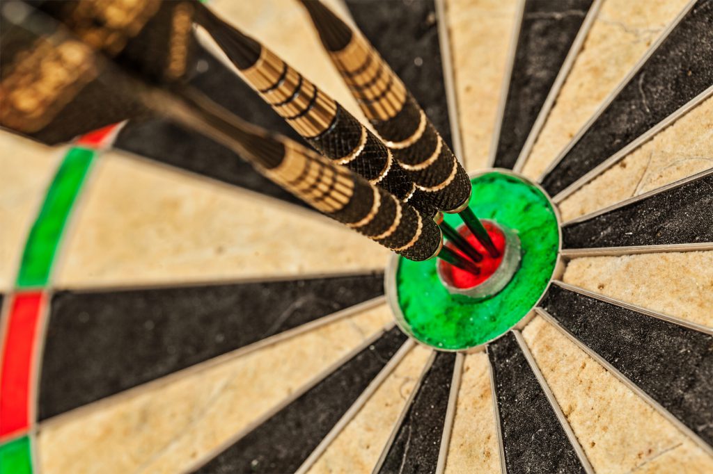 Three darts in bull's eye close up