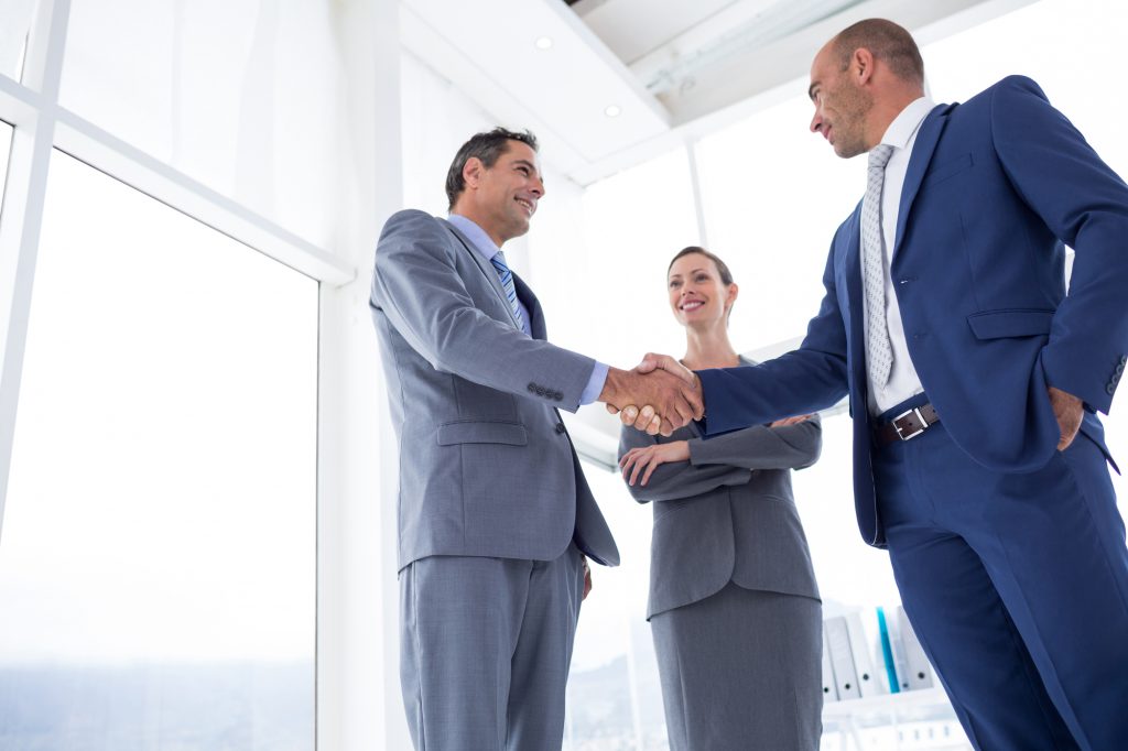 Business colleagues greeting each other in the office